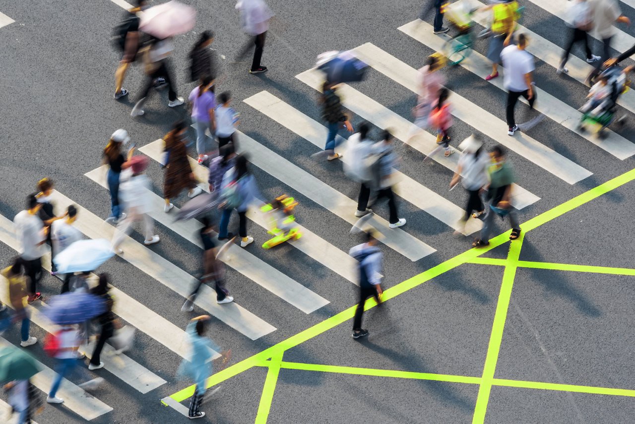 People walking on zebra crossing with blurred motion aerial view in Chengdu, Sichuan province, China